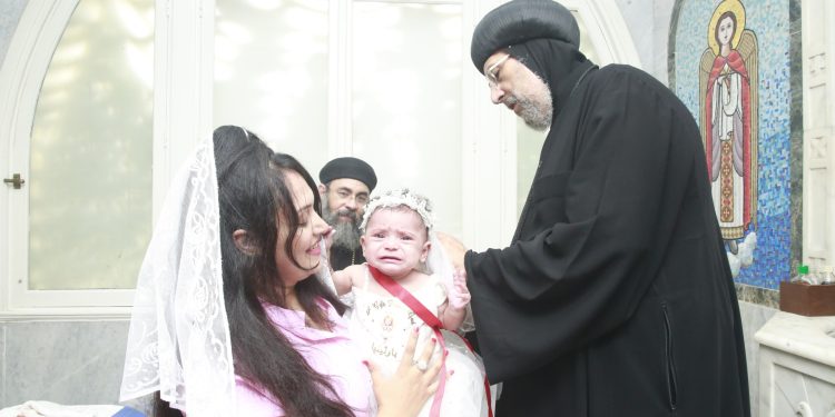 نيافة أنبا إرميا يعمد الطفلة «بارثينيا برسوم تامر»